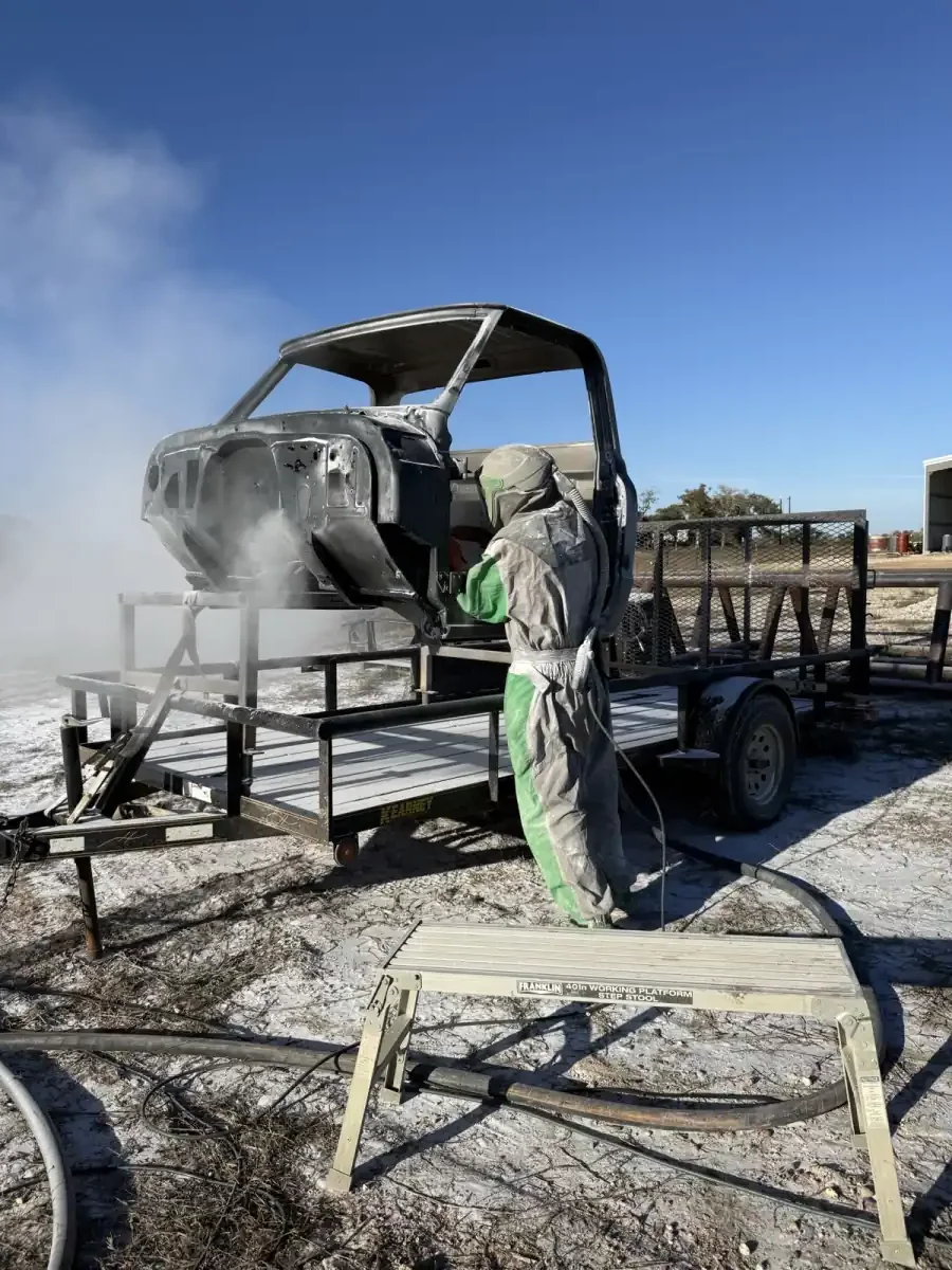 Truck cab being stripped by blasting